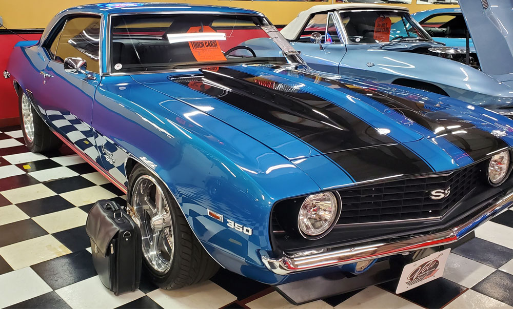 Briefcase inspecting classic camaro