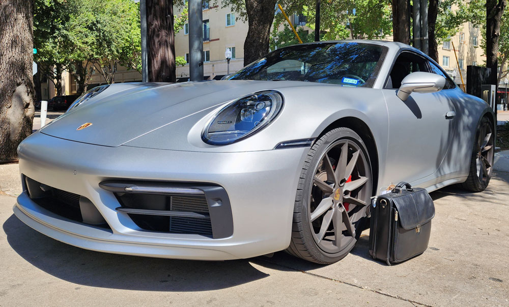 Briefcase inspecting porsche 911